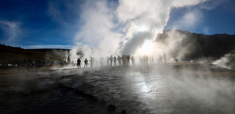 people behind tatio geyser steam in san pedro de atacama