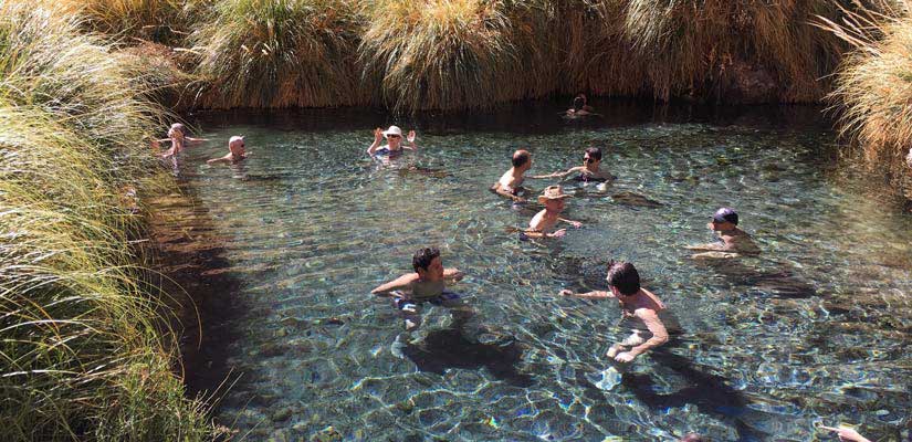 people swimming in the puritama hot springs