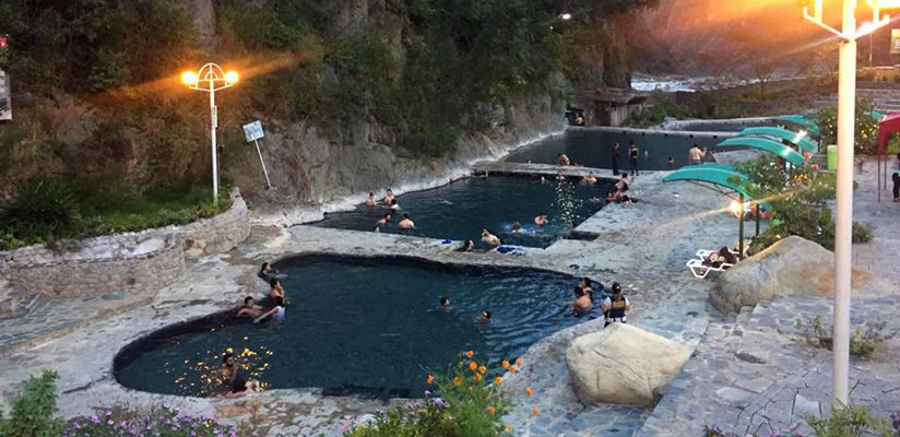 people swimming in cocalmayo hot springs in peru