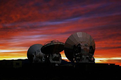 alma observatory telescopes with sunset in the background