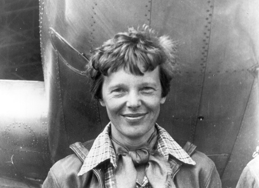 amelia earhart in front of a small plane