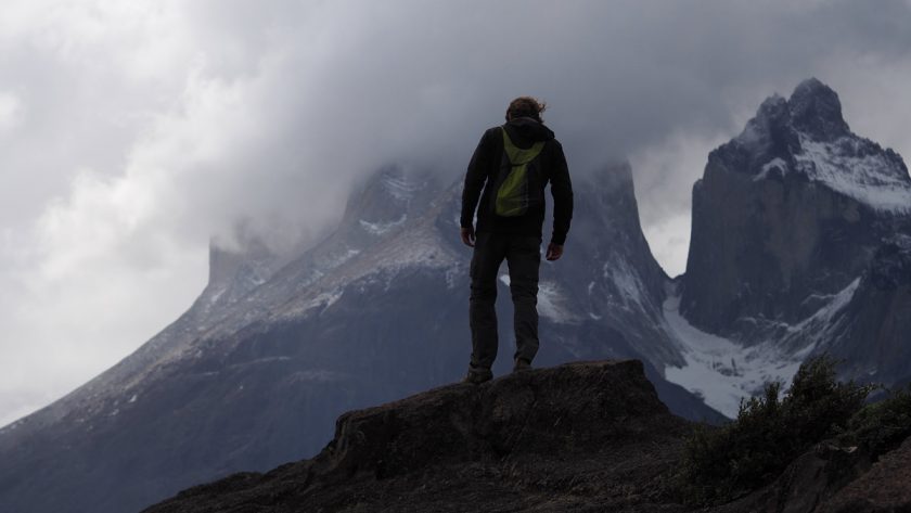 person on top of the mountain in torres del paine