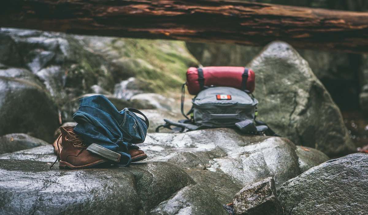 Two trekking backpacks on a rocky surface