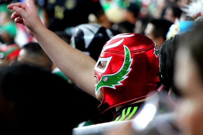 Left side of a Mexican wrestler with red mask