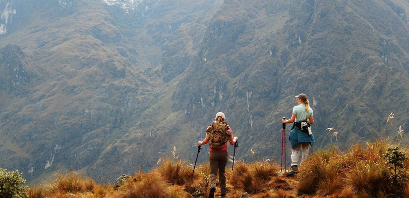 people with trekking poles in the mountains peru