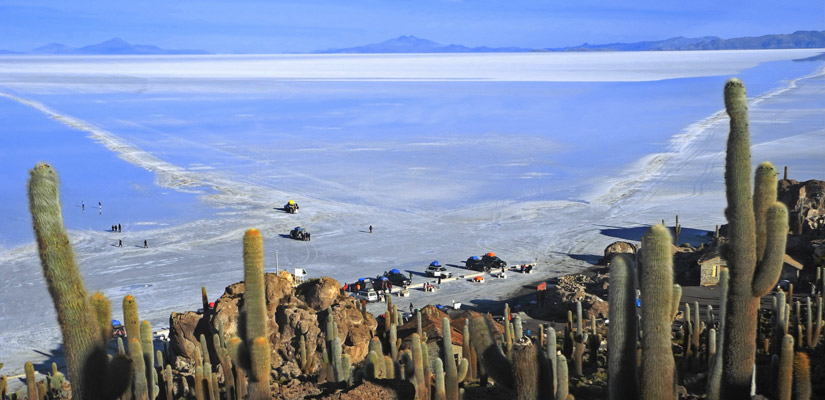 cars with tourists with mirror effect on incahuasi island in the Uyuni Salt Flat