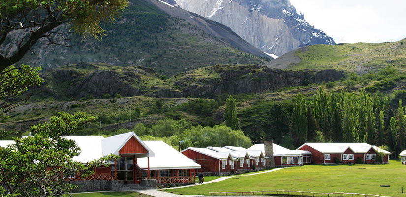 torres paine lodge with mountain in the background as a benefit of sustainable tourism