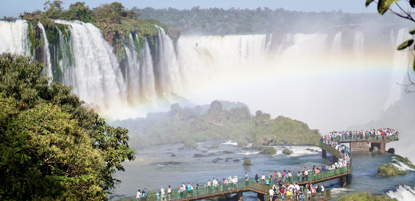 people looking from the viewpoint to the iguazu waterfalls