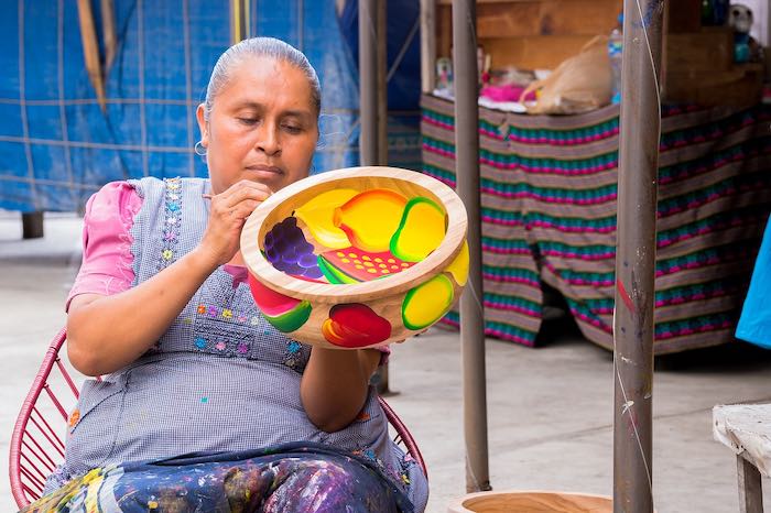 Indigenous Mexican woman making crafts