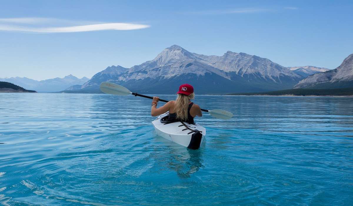 Woman in kayak in a glacier lake