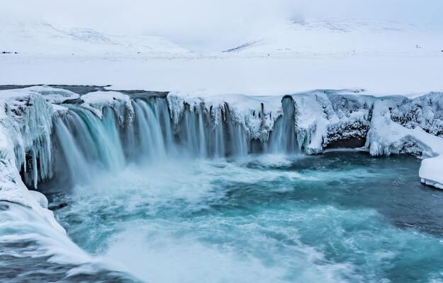 godafoss waterfall covered with ice
